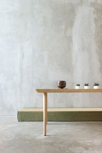round brown ceramic bowl on beige wooden table