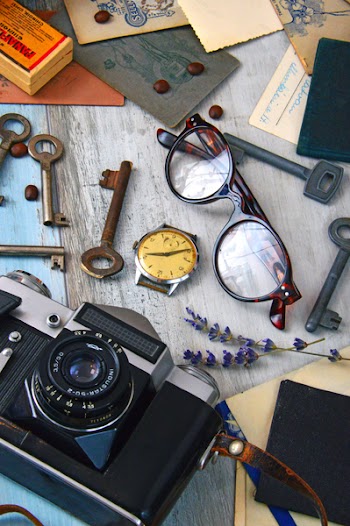 Round Brown Framed Eyeglasses Near Black Camera