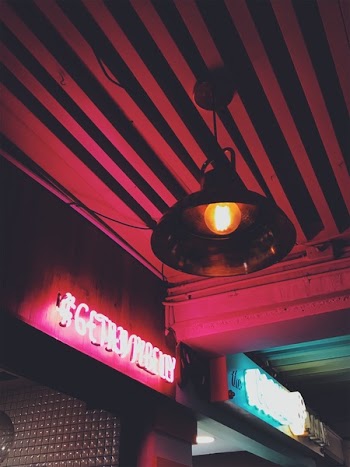 Round Brown Pendant Lamp on Red Ceiling Turned on