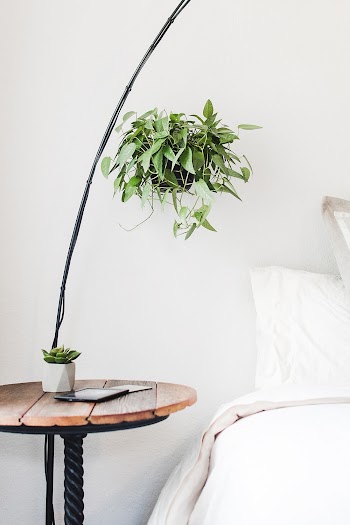 Round Brown Side Table Beside Bed