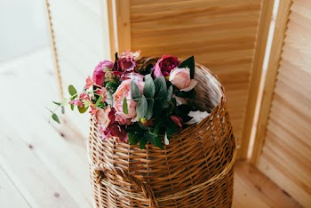 Round Brown Wicker Basket Filled With Pink and Red Flower