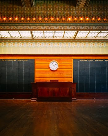 Round Brown Wooden Framed Clock Placed On Wall