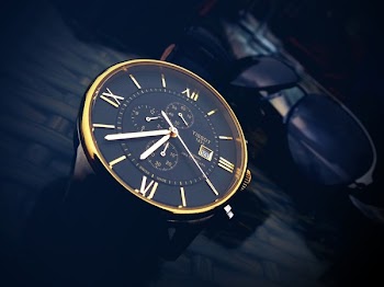 Round Gold-color Chronograph Watch With Black Strap at 7:36