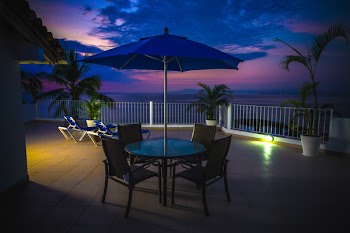 Round Metal Patio Near Railings at Night