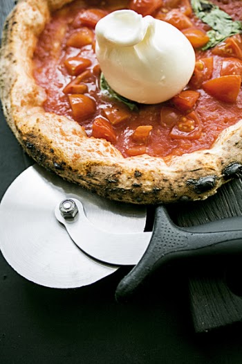 Round Pizza With Black Wooden Surface