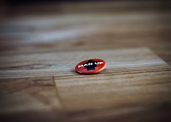 round red and black man up pin back button