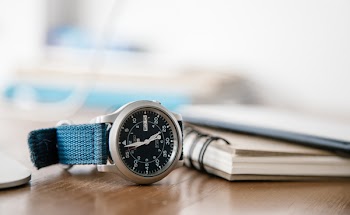 Round Silver-colored Analog Watch on Table