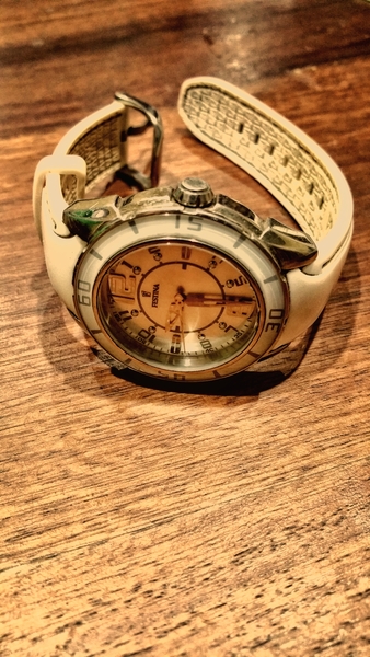 Round Silver-colored and White Analog Watch With White Rubber Band on Brown Wooden Surface