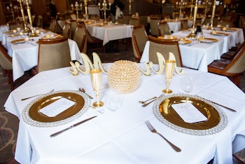 Round Table Covered With White Tablecloth