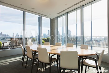 Round table in sunny highrise business conference room