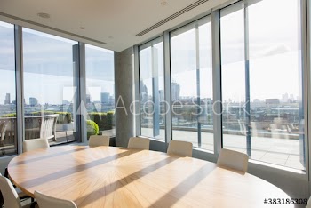 Round table in sunny highrise business conference room