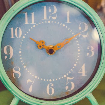 Round Teal and White Analog Table Clock Displaying 10:10 Time
