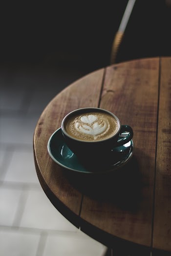 Round Teal and White Ceramic Mug With Saucer Set With Coffee Inside