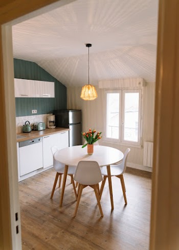 Round White and Brown Table With Four Chairs