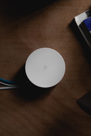 Round White Corded Device On Brown Surface