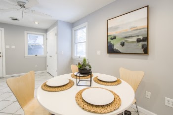 Round White Table With 4 Ceramic Plates On Top