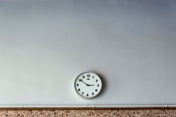 round white wall clock reading at 2:50