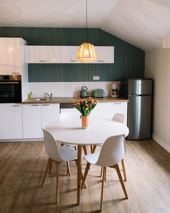 Round White Wooden Table and Three White Chairs