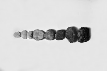 Row of Black and Gray Polished Pebble on Gray Surface