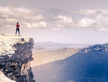 rule of thirds photography of woman on top of mountain