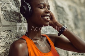 Runner enjoying listening music while having break