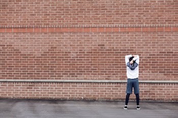 Runner Stretching By Brick Wall