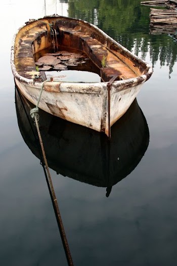 Rusted River Boat On Clear Water