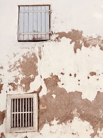 Rustic Windows And Shutters On Plaster Wall