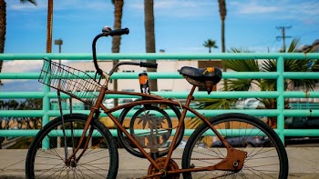 Rusty Bike Parked On Boardwalk