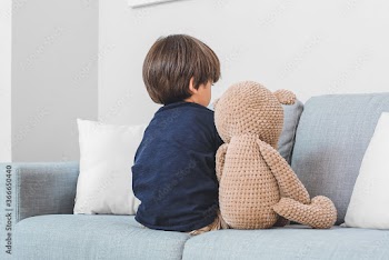 Sad little boy with autistic disorder at home