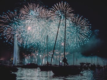 sail boats on water with firework displays