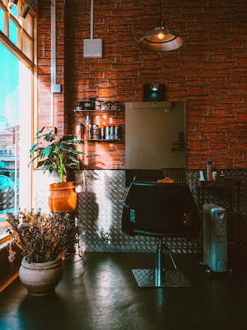 Salon Chair Beside Oil Heater in Front of Mirror Inside Room