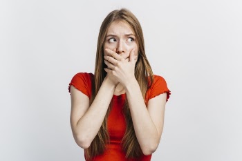 Scared woman covering her mouth Free Photo