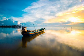 Scenic Photo Of Boat During Dawn