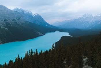 Scenic Photo Of Mountains Under Cloudy Sky