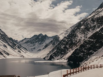 Scenic Photo Of Snow Capped Mountains Under Cloudy Sky