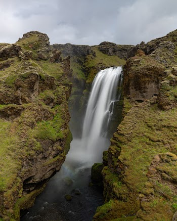 Scenic Photo Of Waterfalls Under Cloudy Sky