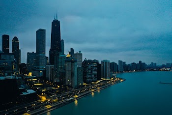 Scenic View Of City Under Cloudy Sky