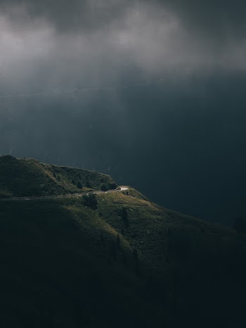 Scenic View Of Mountain Under Cloudy Sky