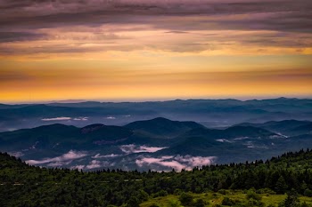 Scenic View of Mountains Against Cloudy Sky
