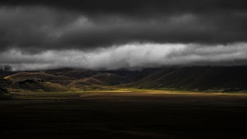 Scenic View Of Mountains Under Cloudy Sky