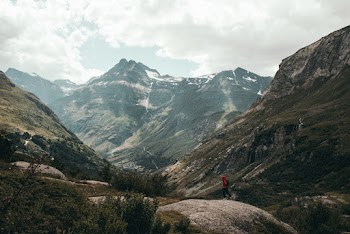Scenic View Of Rocky Mountains Under Cloudy Sky