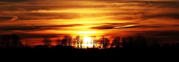 Scenic View of Silhouette Landscape Against Sunset Sky