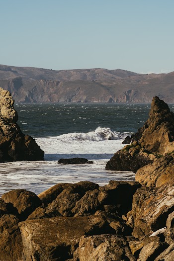 Scenic View Of The Sea Surrounded By Rocky Hills And Mountains
