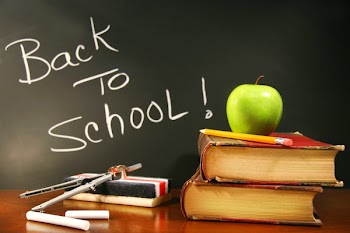 School books with apple on desk