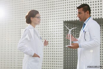 Scientists with wind turbine model