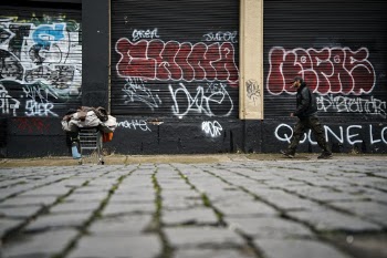 SE Portland street life, all your belongings in a shopping cart.  Constantly on the move in a sea of Graffiti.