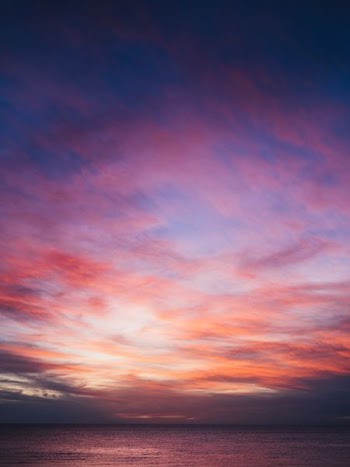 sea under sunset and cloudy sky