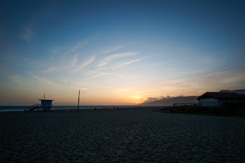 Seashore Under Blue Sky With Brown Clouds during Sunrise
