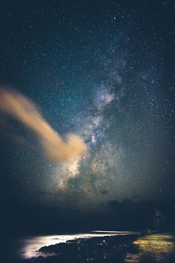 seashore under milky way